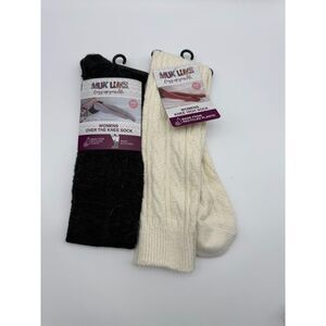 MUK LUKS women's knee-high, over-the-knee socks, one in black and one in ivory.